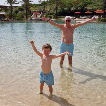 child and grandfather tropical beach