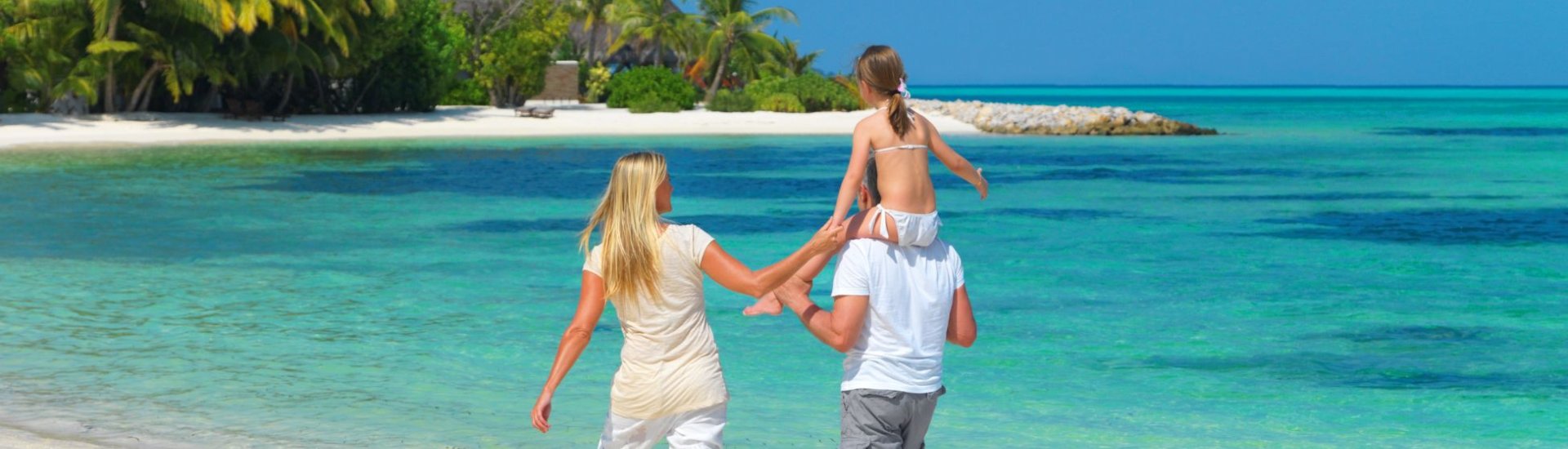 photo of family walking by the beach