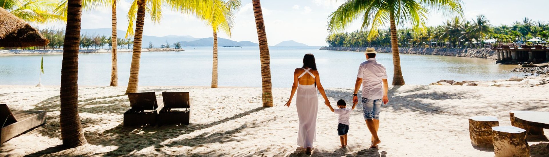 Married couple on beach with child