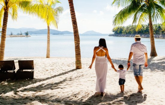 Married couple on beach with child