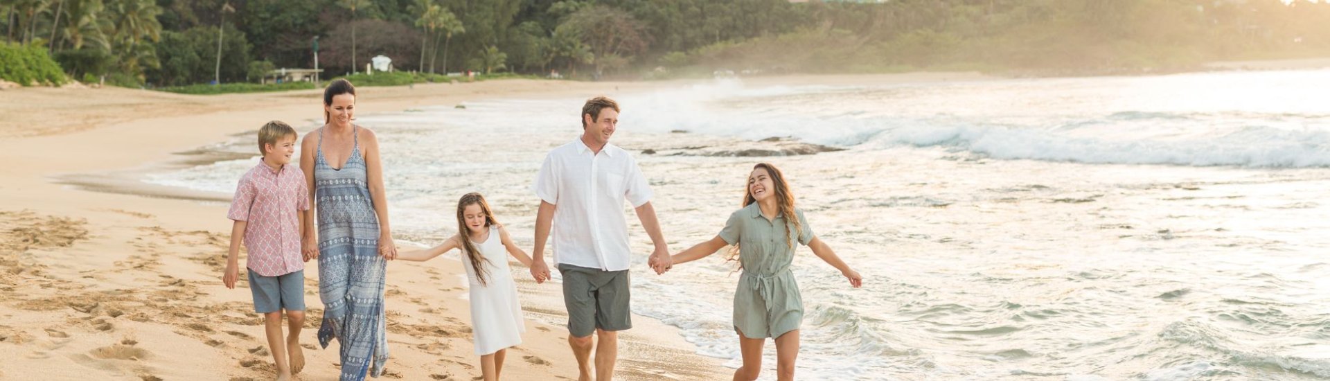 family having fun at sunset on a beach