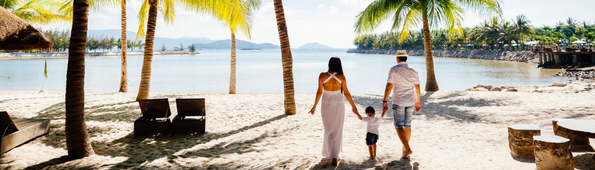 married couple with toddler on a beach